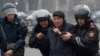 Kazakhstan Protests -- Police officers detain a demonstrator during a protest in Almaty, Kazakhstan, Wednesday, Jan. 5, 2022. Demonstrators denouncing the doubling of prices for liquefied gas have clashed with police in Kazakhstan's largest city and held 