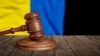 UKRAINE – Judge's law gavel with flag of Ukraine on desk